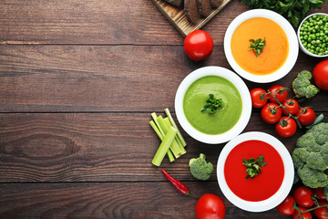 Vegetable cream soup with parsley on wooden table