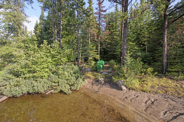 Canoe on Shore in a Hidden Campsite