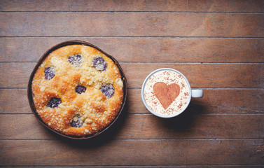 Christmas pie and cup of coffee with heart shape