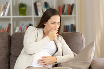 Pregnant woman with nausea at home