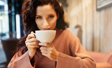 woman drinking coffee in a cafe