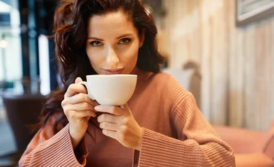 Selbstklebende Fototapeten woman drinking coffee in a cafe © Izabela Magier
