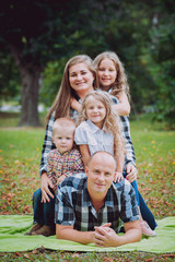 Young family with cheerful children in the park