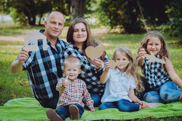 Young family with advertising signs in the park.