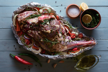 Raw lamb leg, marinated with herbs