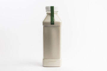 Organic nutty milk nutrition in plastic bottle on the white background. Detox juice diet. Big size bottle