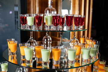 Green and orange cocktails stand on the bar