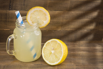 Water and lemon juice on wooden background