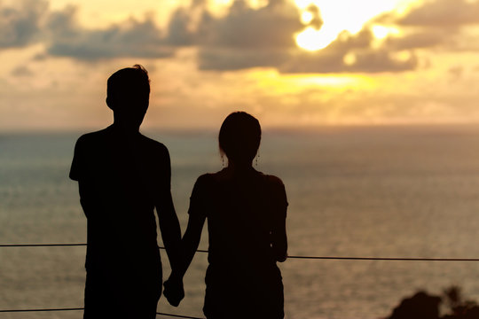 silhouette of a couple in love looking the sunset