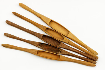 Wooden weaving shuttle isolated on white background.