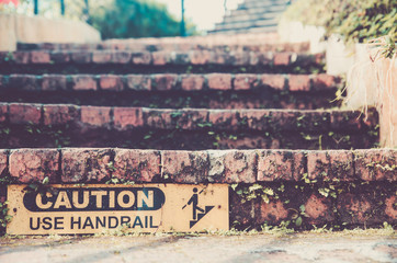 brick stair and caution sign to use handrail vintage , retro