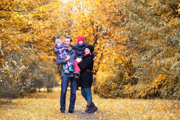 Family in autumn park in the afternoon