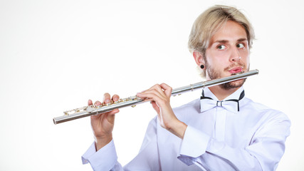 Male flutist playing his flute © anetlanda