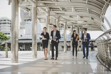 Business people walking to go meeting in office.