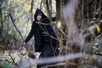 A woman in a witch suit in a forest