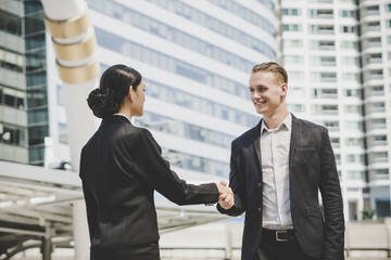 Business people shaking hands, finishing up meeting deals. Business concept.