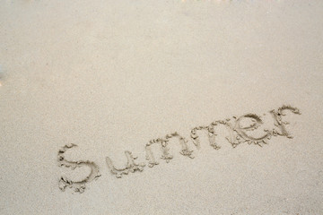 The word Summer in the sand of a beach.