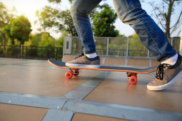 skateboarder legs skateboarding on skatepark ramp