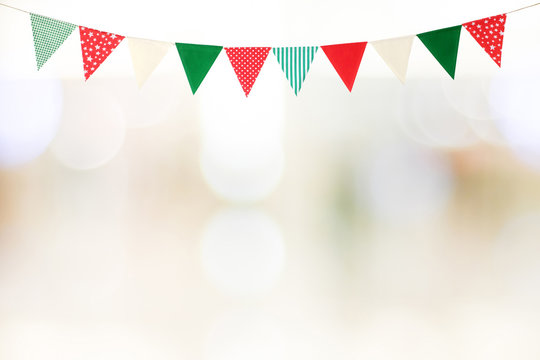 Christmas and new year bunting party flags over blur festive bokeh light background