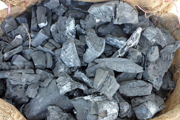 wooden charcoal in sacks.