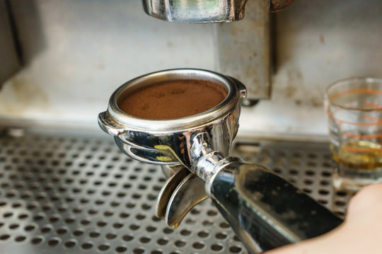 Barista Barister makes coffees in coffee bar.espresso preparation in coffee machine.Hands bartender cooking coffee, Interior bar, bartender, shallow depth of field.Coffee grinder