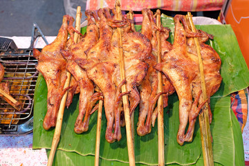 roast chickens on banana leaf.