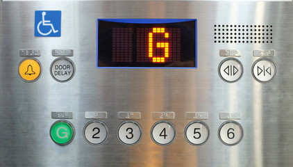 Elevator internal buttons control panel, Braille numbers and lift symbols.