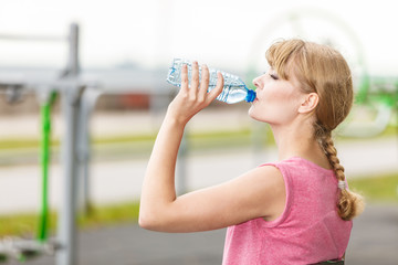 Woman with drinking water taking break. Fitness.