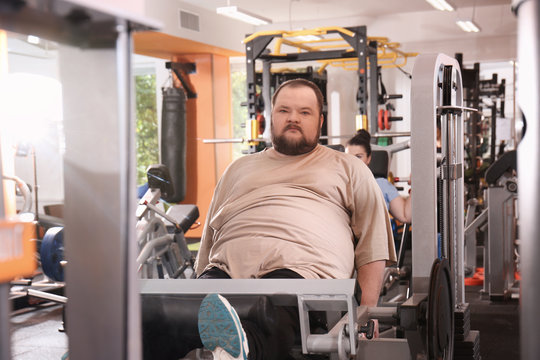 Overweight Man Training In Gym