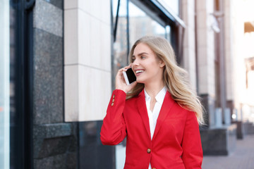 Young businesswoman talking on mobile phone outdoors