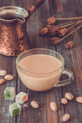 Turkish pistachio coffee brewed in turk with milk, pistachios and turkish delight