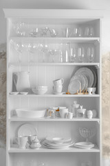 Storage stand with glassware and tableware indoors