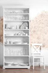 Storage stand with glassware and tableware indoors