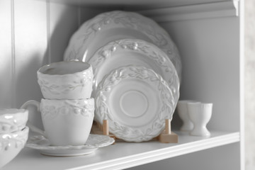 Storage stand with tableware indoors