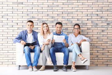 Group of people waiting for job interview on sofa