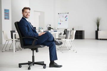 Young handsome man in office