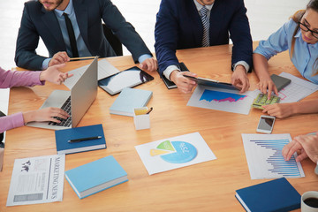 Team of young managers discussing project in office © Africa Studio