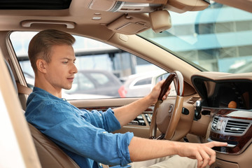 Young man on driver seat of car