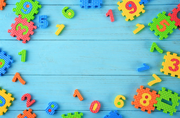 Pieces of math puzzle scattered on blue background