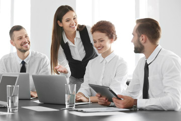 Team of young professionals conducting business meeting in office