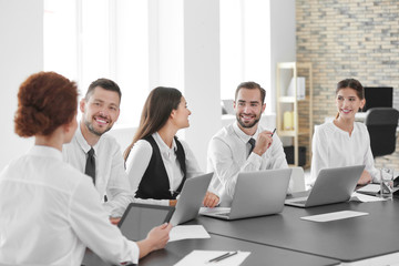 Team of young professionals conducting business meeting in office