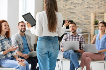 Team of young professionals conducting business meeting in office