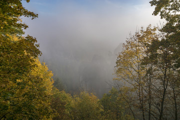 Fairytale, foggy sunrise over the Saxon Switzerland park in Germany