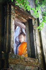 Old Buddha statute in the old ruin temple. 