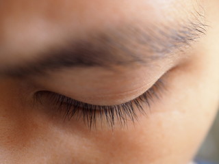 Close up nature close Asian woman yellow skin, no make up eyelid with long black eyelash and eyebrow, left eye area