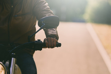 filter and grain photo ; man riding motorbike on a road in freedom lifestyle at vacation time