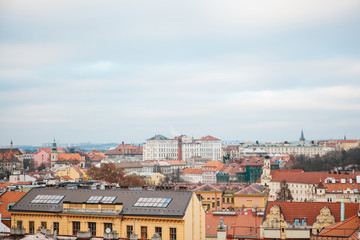 Fototapeta na wymiar View from a high point. A beautiful view from above on the streets and roofs of houses in Prague. Traditional ancient urban architecture.