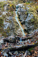 Long exposure of a small waterfall coming down through rocks and moss