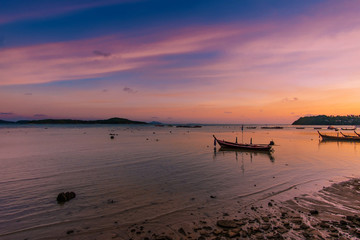 fishing boats are parking on the sea beside Rawai beach at sunset, Phuket, Thailnad.