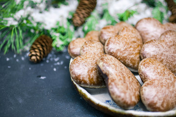 Christmas gingerbreads in the form of heart. Christmas composition on the background of fir-tree branches